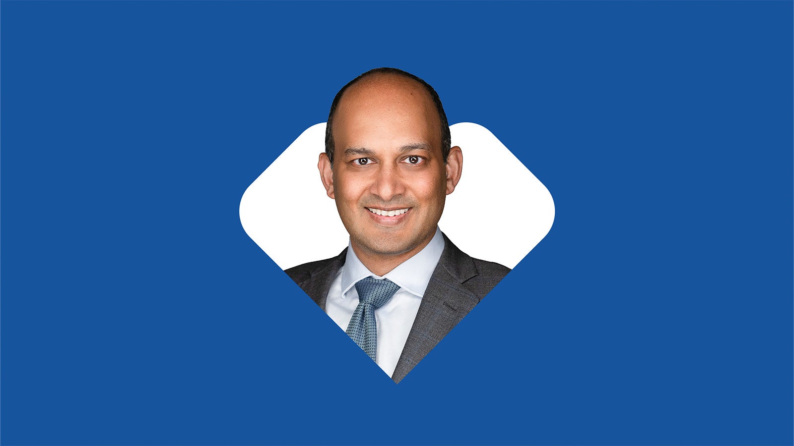 Sree Chaguturu in front of white heart & dark blue background