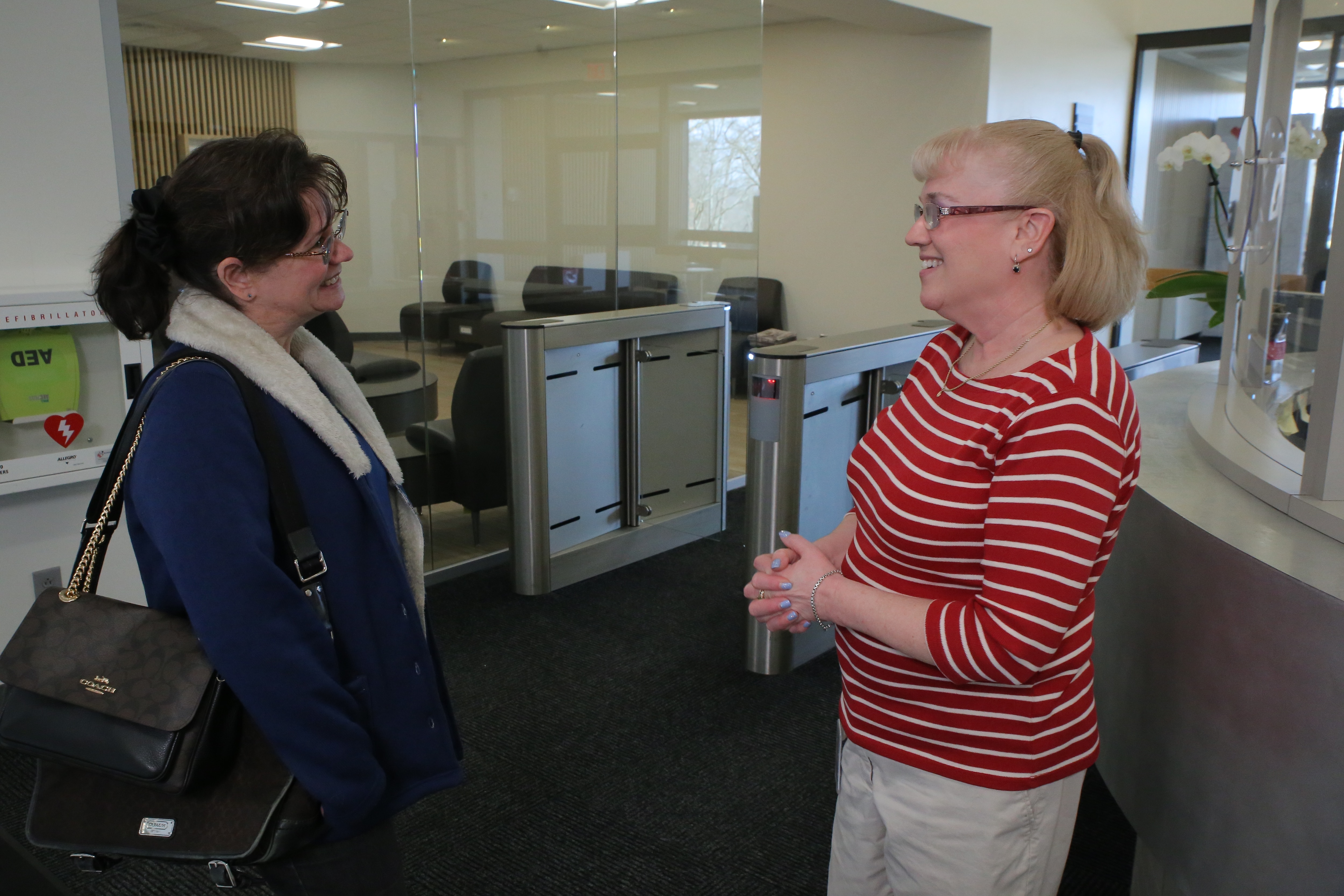 CVS Health colleagues Lea Bousquet and Therese Switzer talk in the office