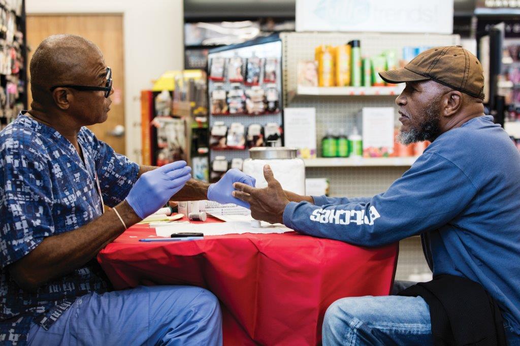 Medical professional talks with a patient during health screening at CVS