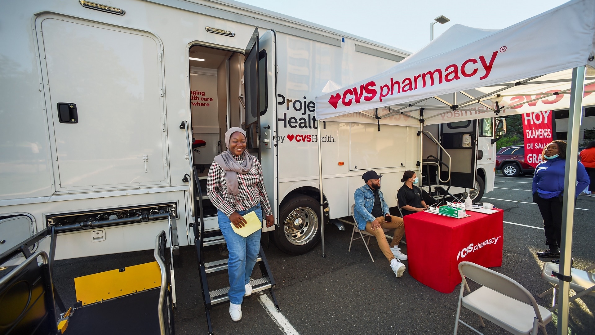 Four people at a CVS Pharmacy mobile van for health screenings