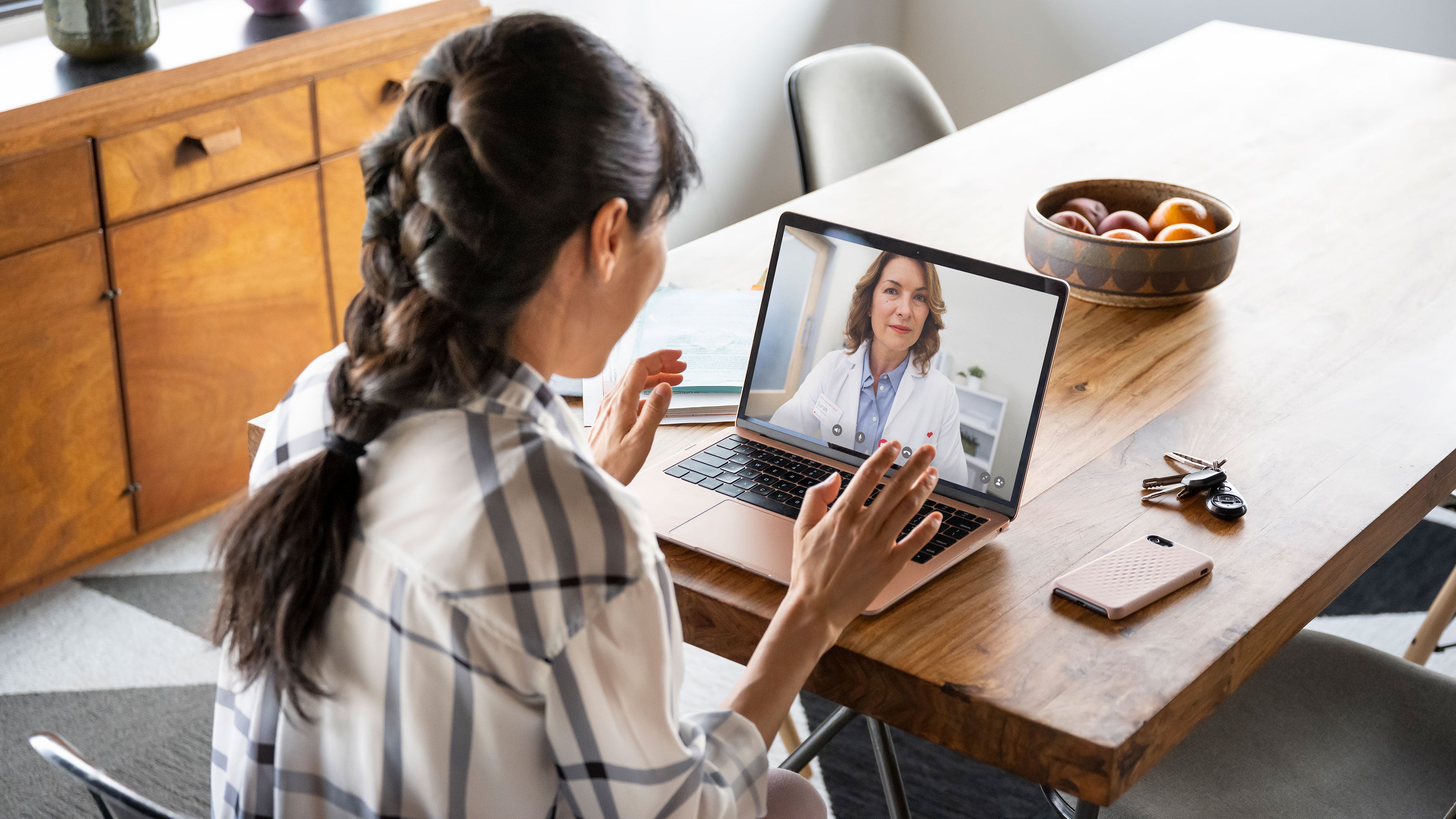 Woman having a telehealth visit on a laptop