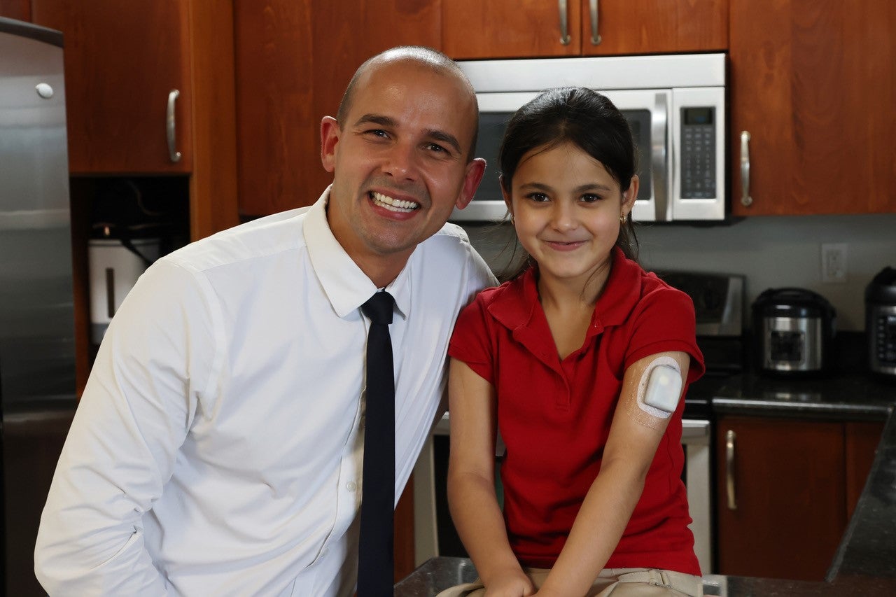 Pharmacist Orlando Vega and his 7-year-old patient Yazmin
