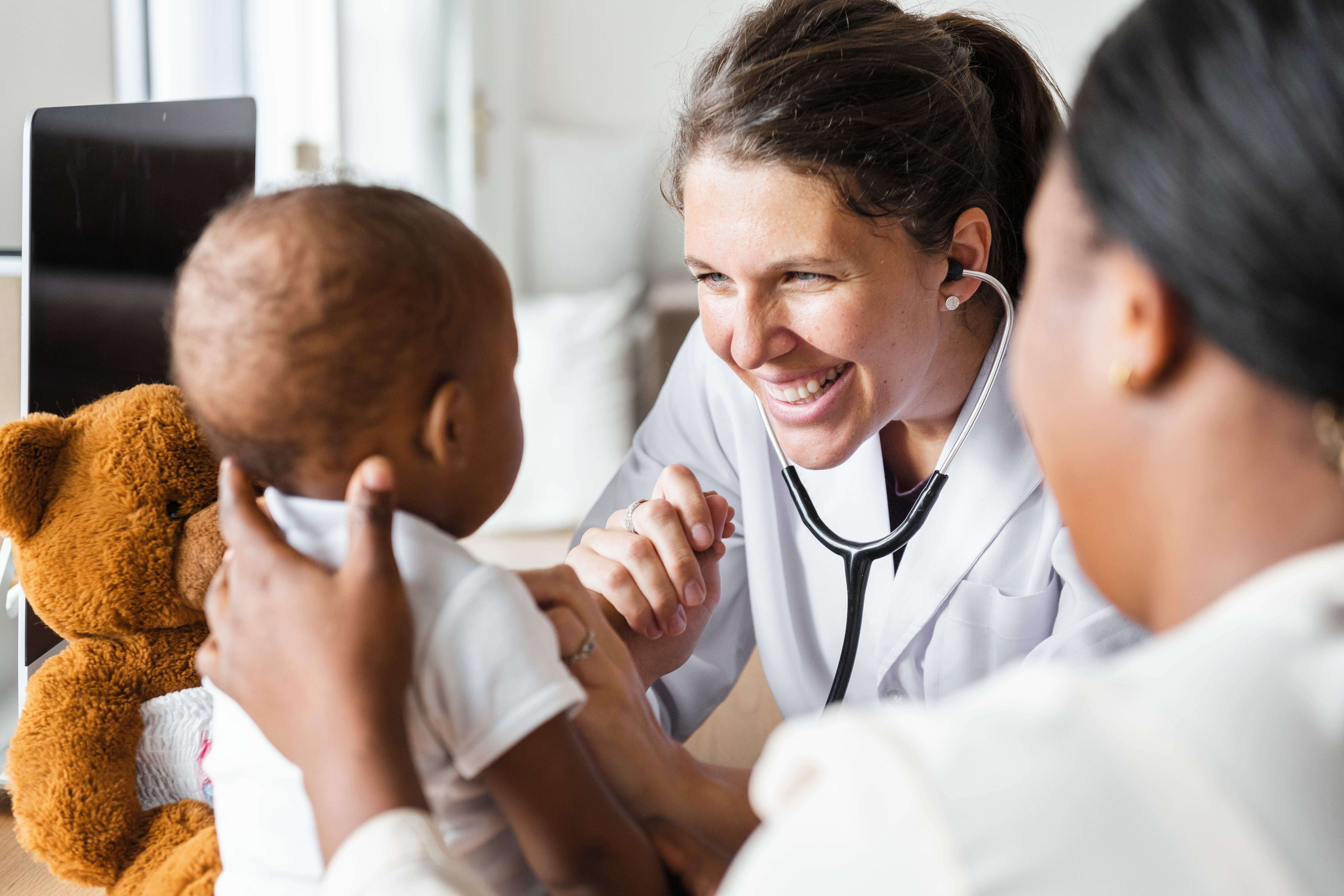 Health care provider examining an infant