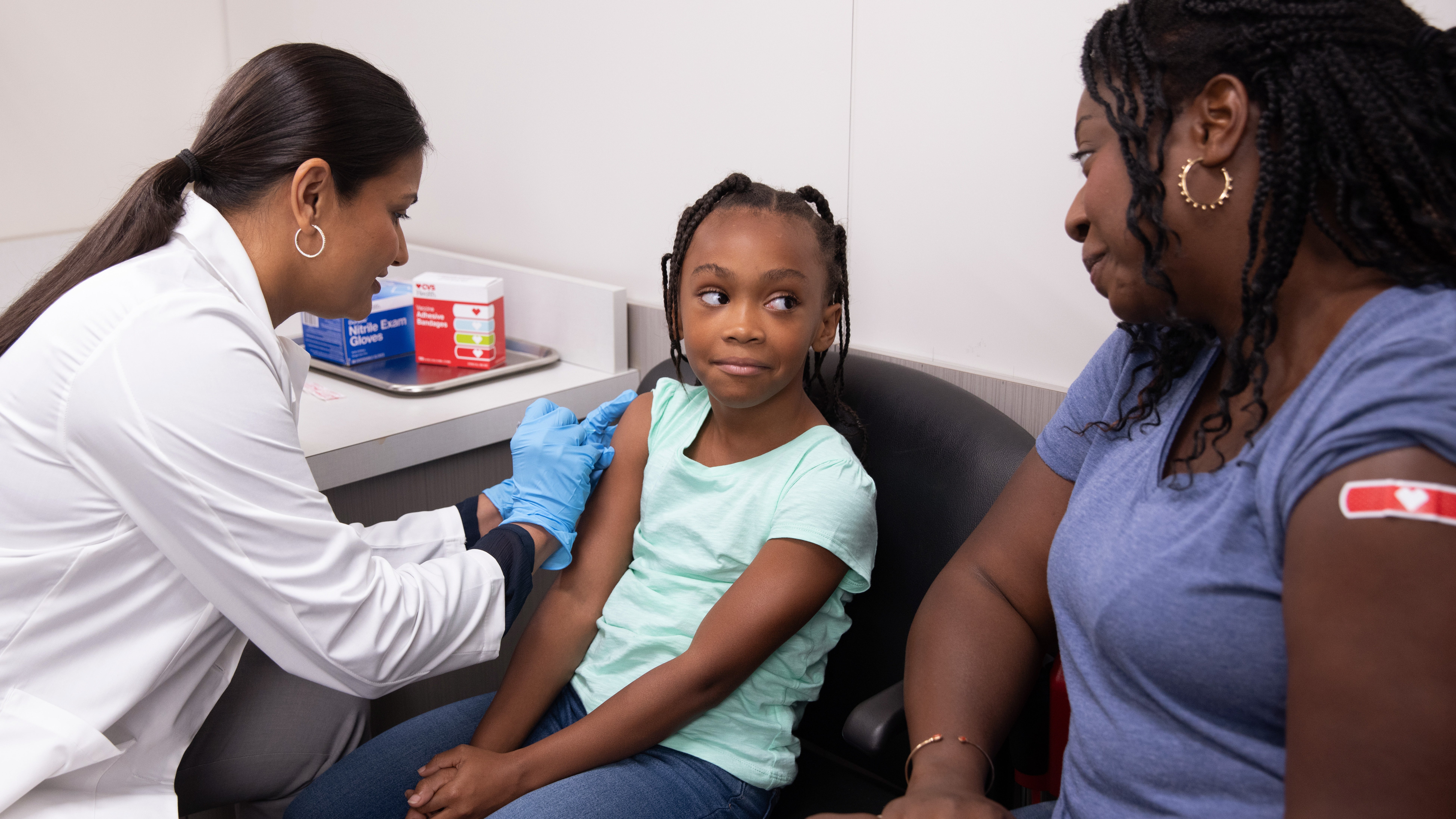 Health care provider giving child a flu shot