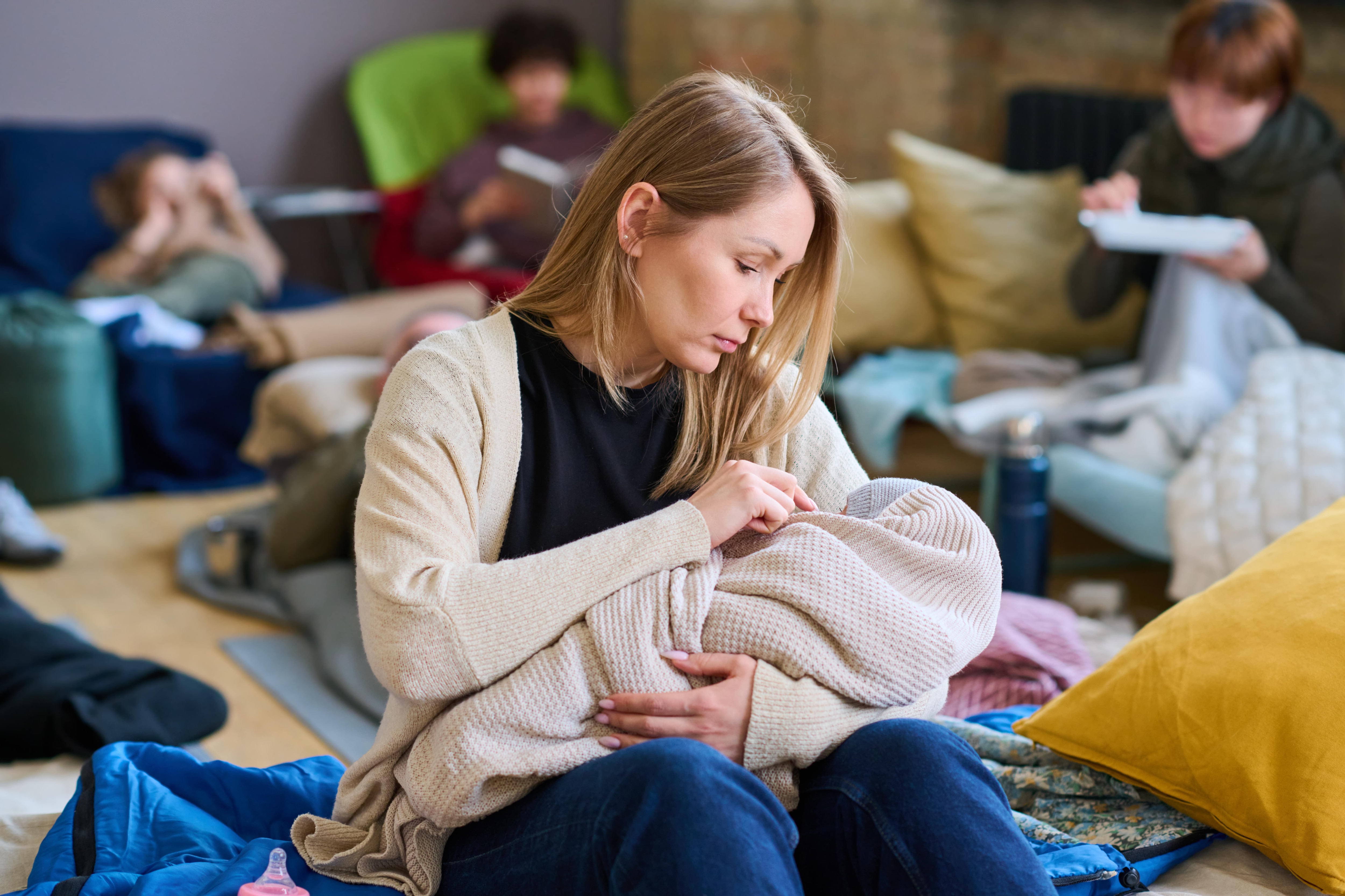 Mother holding a baby wrapped in a blanket