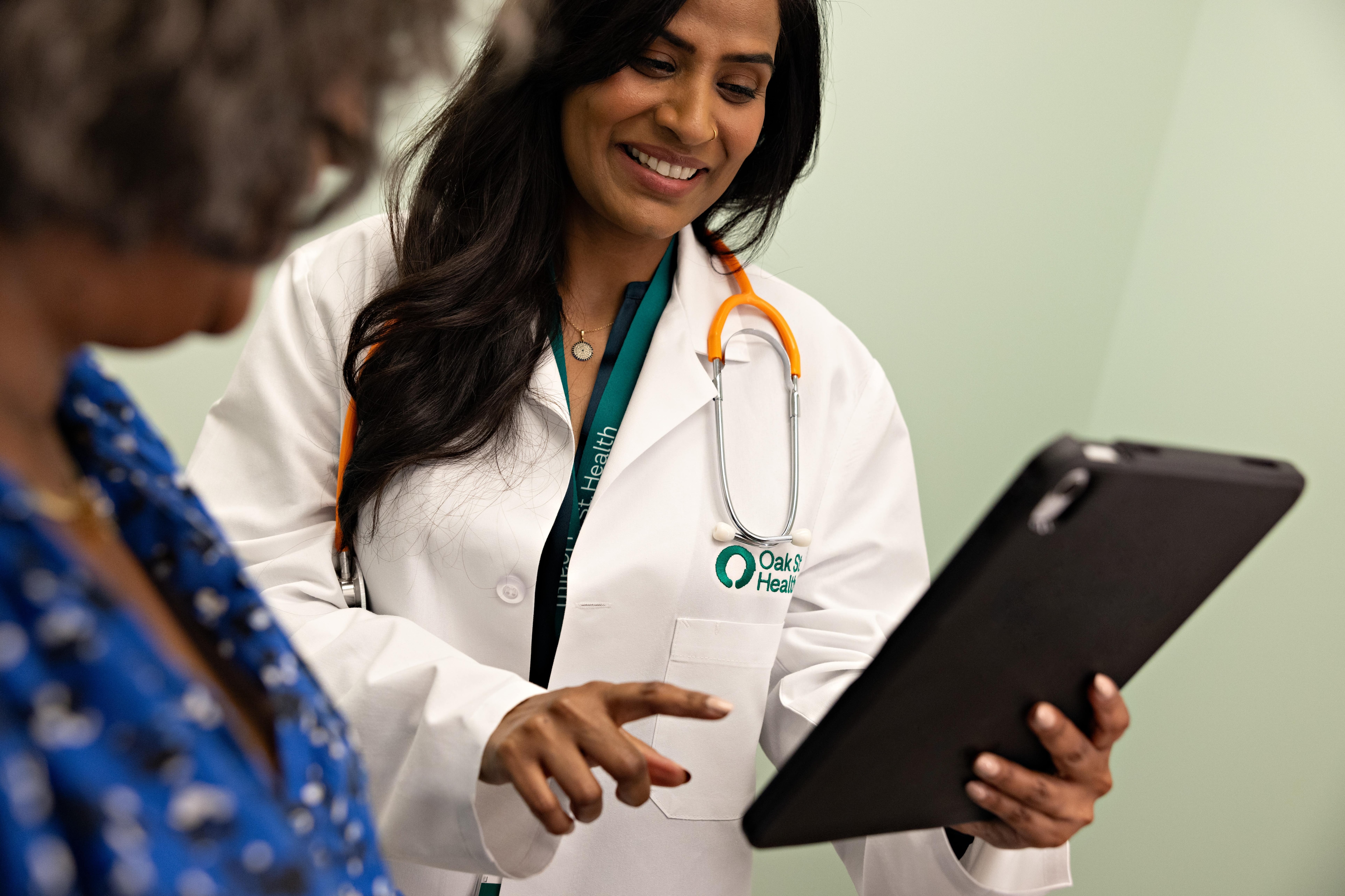 Oak Street practitioner working with a patient 