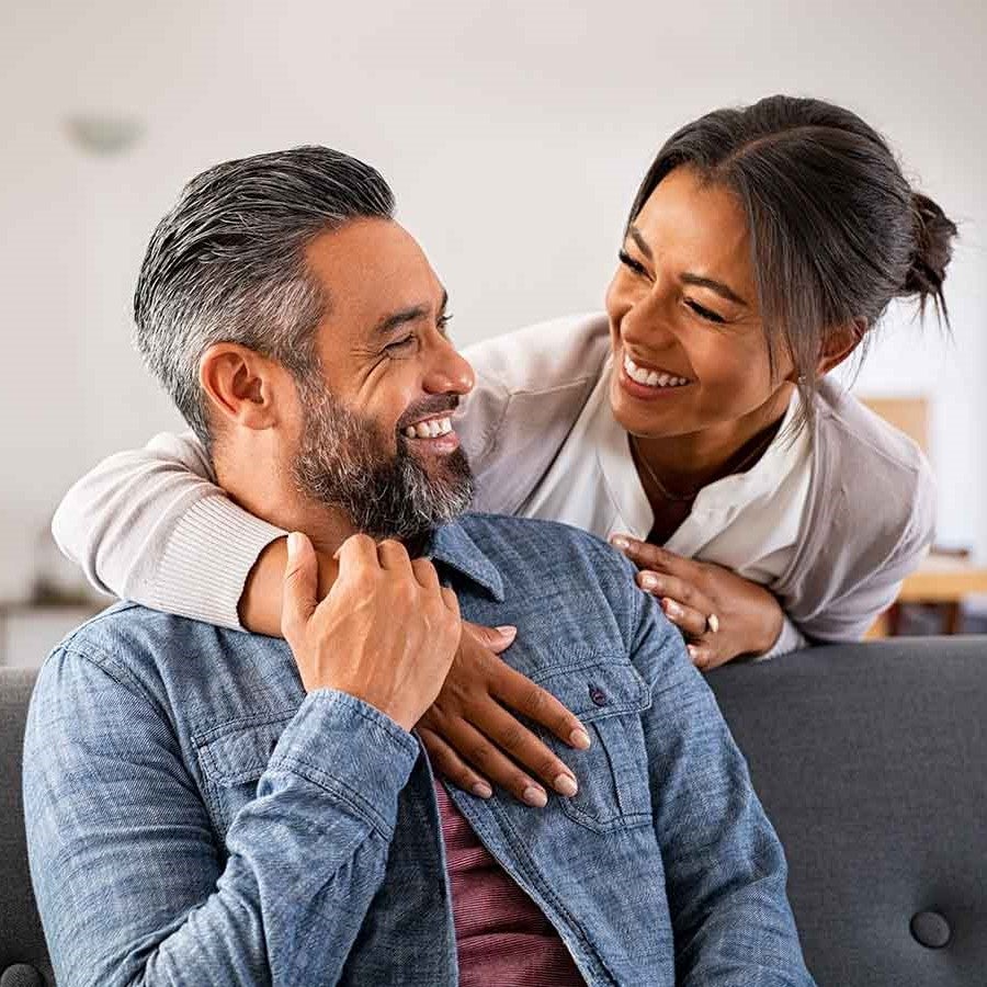 A couple share a happy moment with a slight embrace