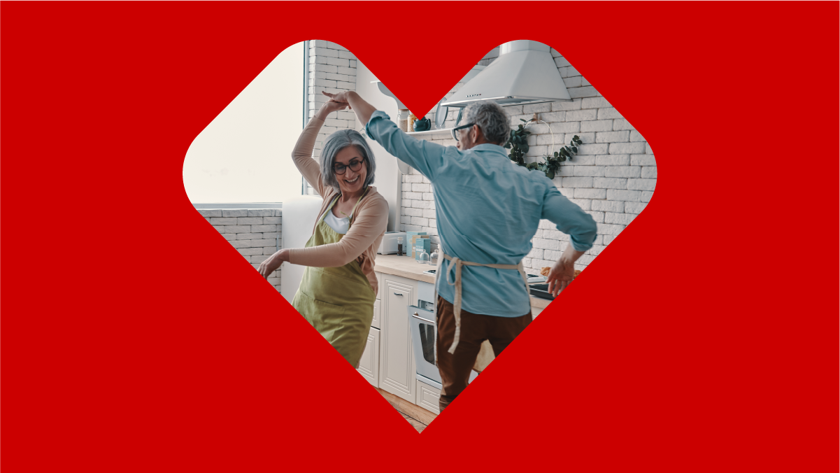 An older couple seen dancing in a modern-looking kitchen