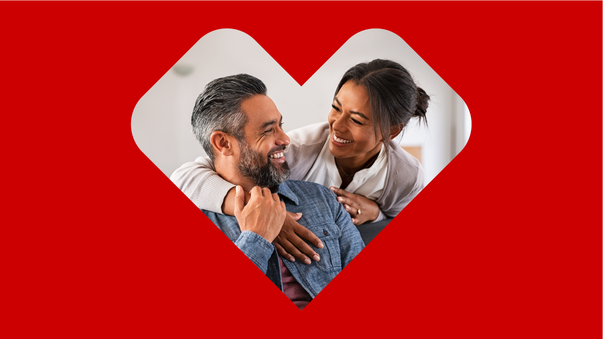 A couple shares a happy moment with a slight embrace.