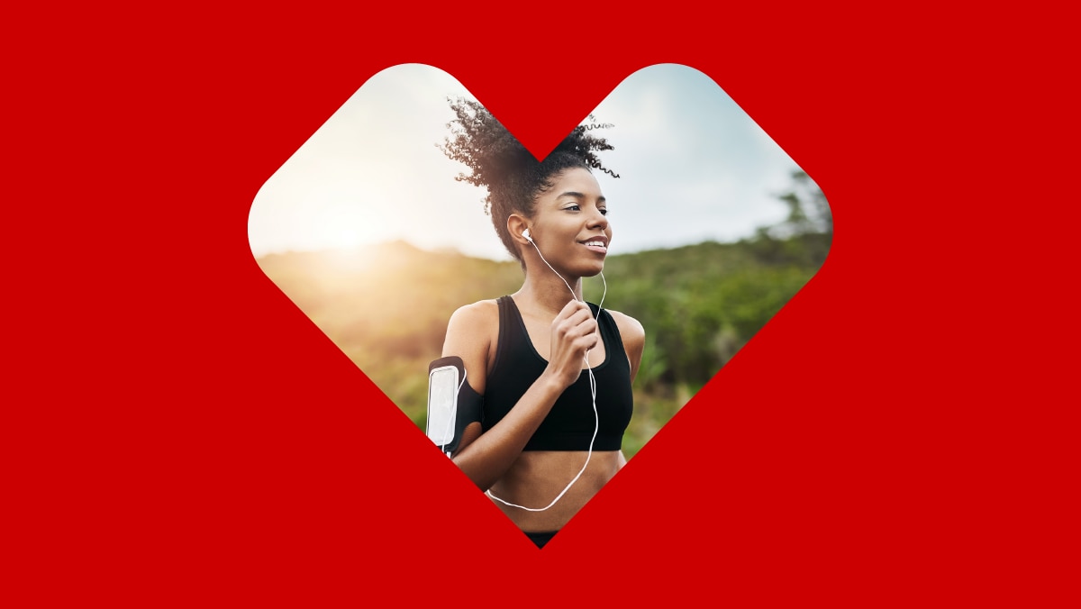 A red overlay of a heart reveals a woman, wearing athletic clothes and headphones, runs on a paved road with her phone strapped to her arm.