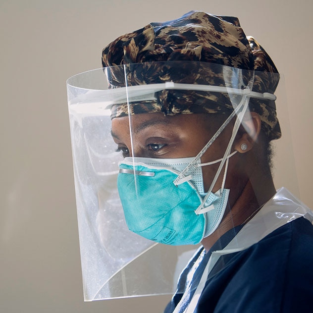 Medical professional in surgical mask and face shield
