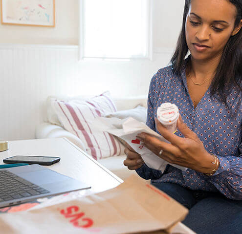 Female reviewing prescription information from CVS Pharmacy