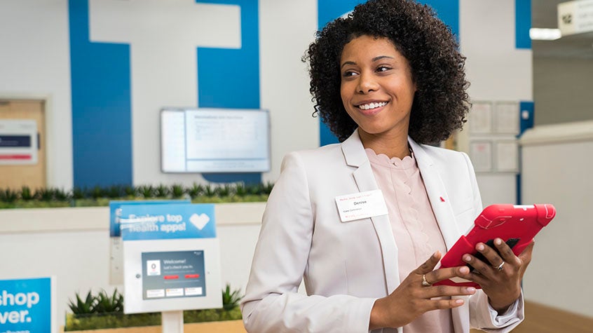 Woman smiling with tablet in hand