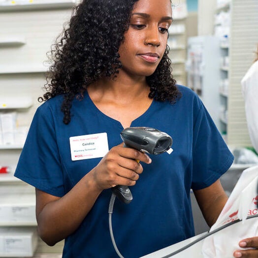Female pharmacist filling prescription