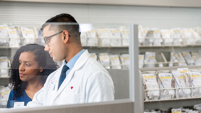Two CVS employees working together in pharmacy