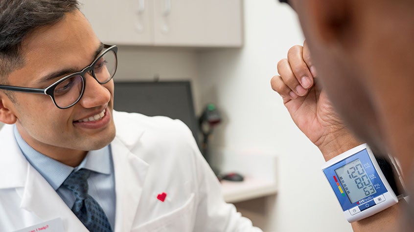Doctor smiling while checking patients vitals