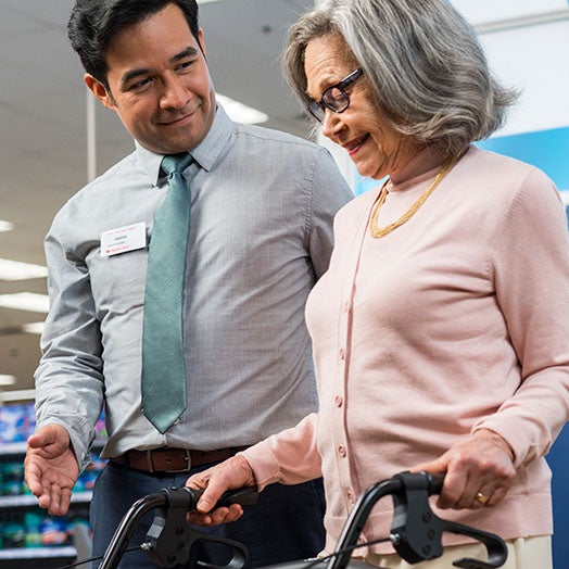 Male helping female with walker