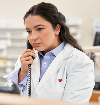 CVS female pharmacy professional talking on the phone