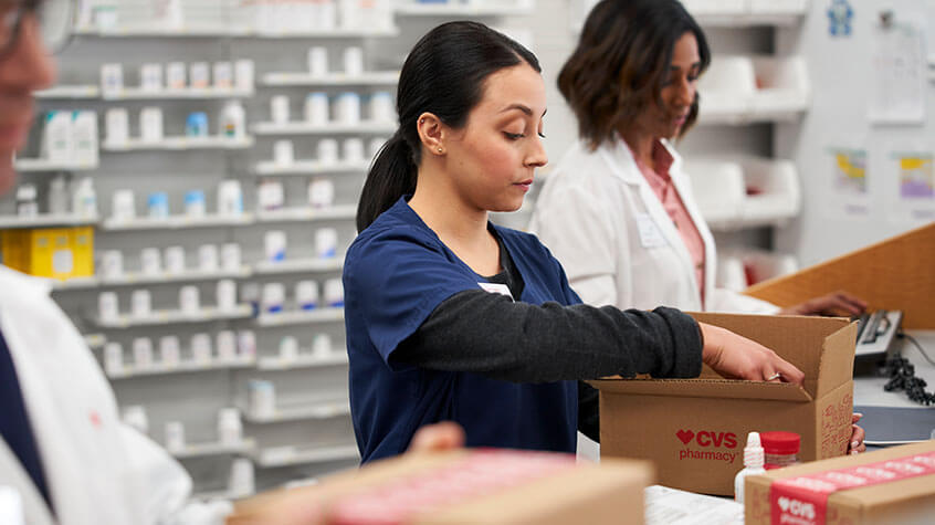 Woman unpacking box at CVS Pharmacy