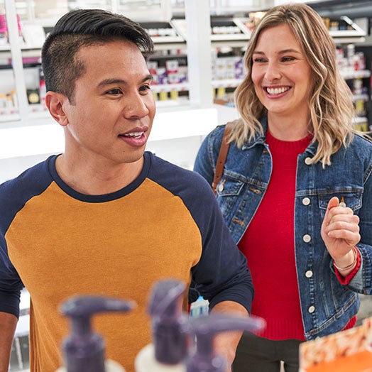 Male and female shopping for skin products at store