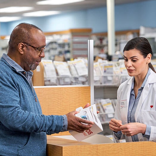 Female pharmacist assisting male patient at CVS Pharmacy