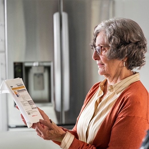 Older woman reviewing prescription information