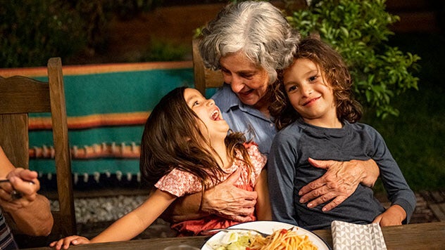 Grandmother holding two grandchildren
