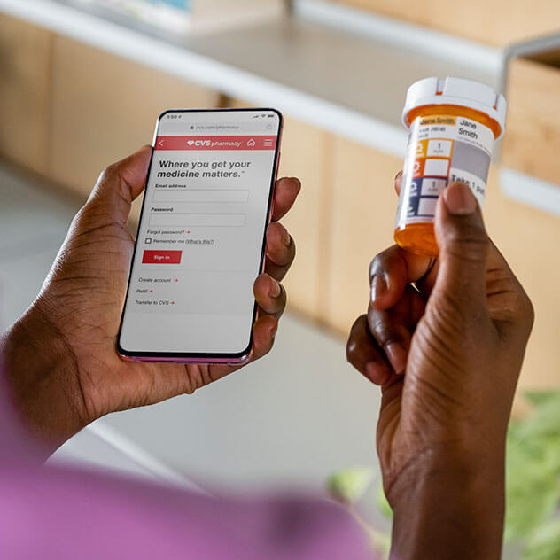 Person ordering prescription refill on mobile device