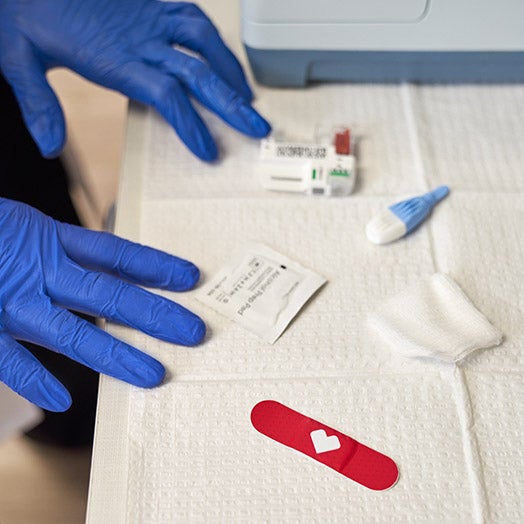 Medical professionals hands with supplies for diabetes exam