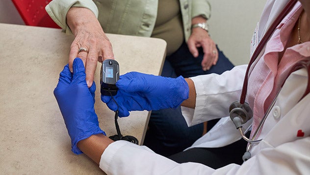 Doctor taking patients pulse