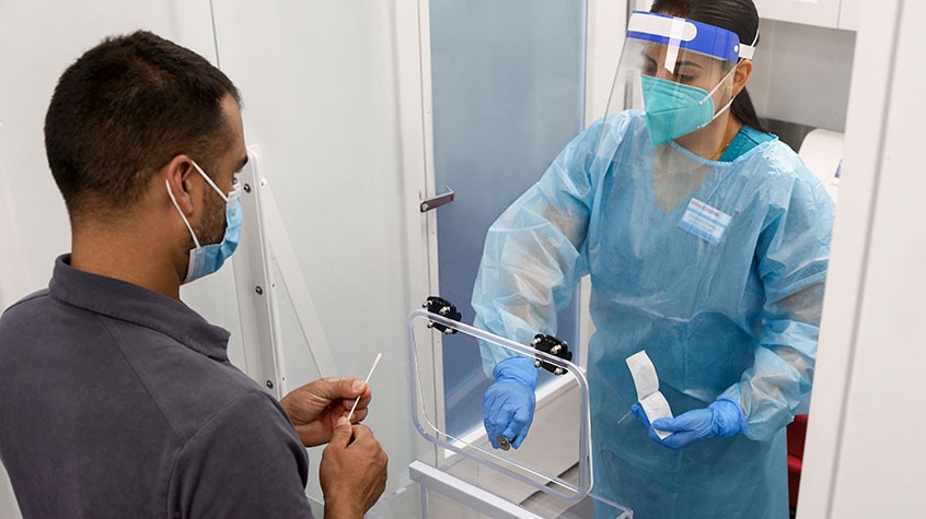 Female medical provider preparing man to receive a vaccine