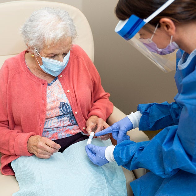 Female medical professional reviewing results with older female patient