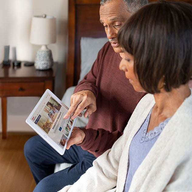 Male and female reading on tablet together
