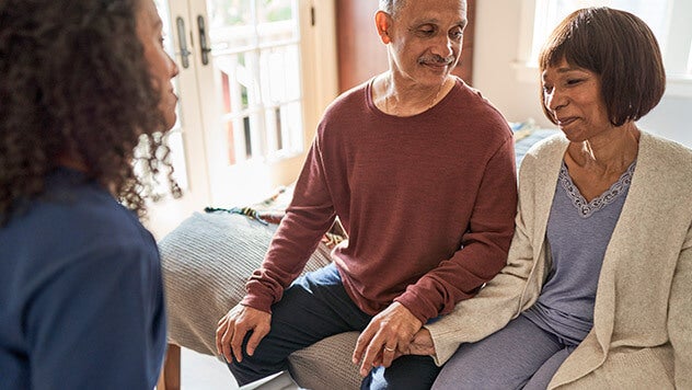 Medical professional speaking to patient and husband
