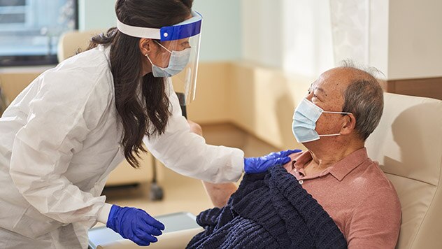 Female medical professional comforting male patient