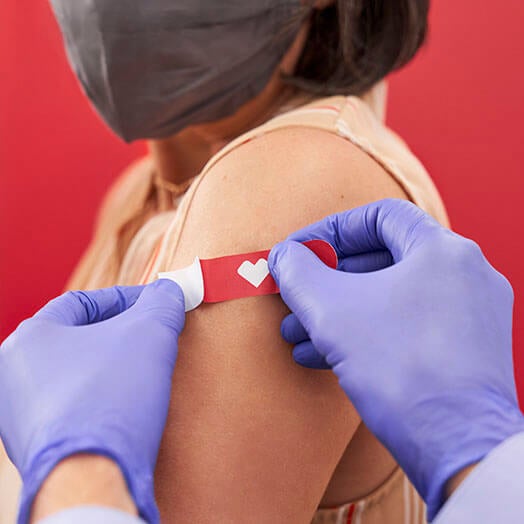 Pharmacist placing CVS bandage onto patient