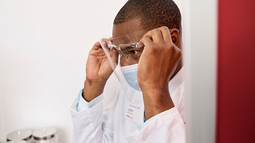 Male medical provider wearing a mask and face shield