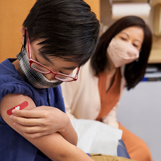 Patient placing bandage on arm