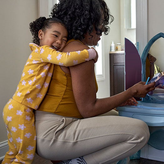 Daughter hugging mother from behind