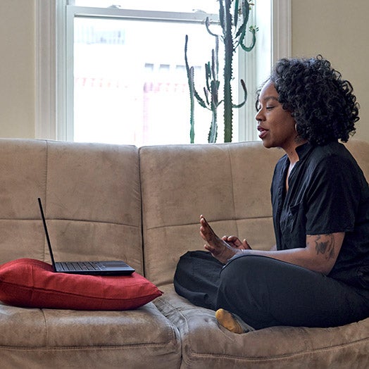 Woman sitting on couch at home