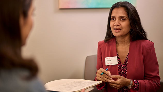 Two women speaking in office