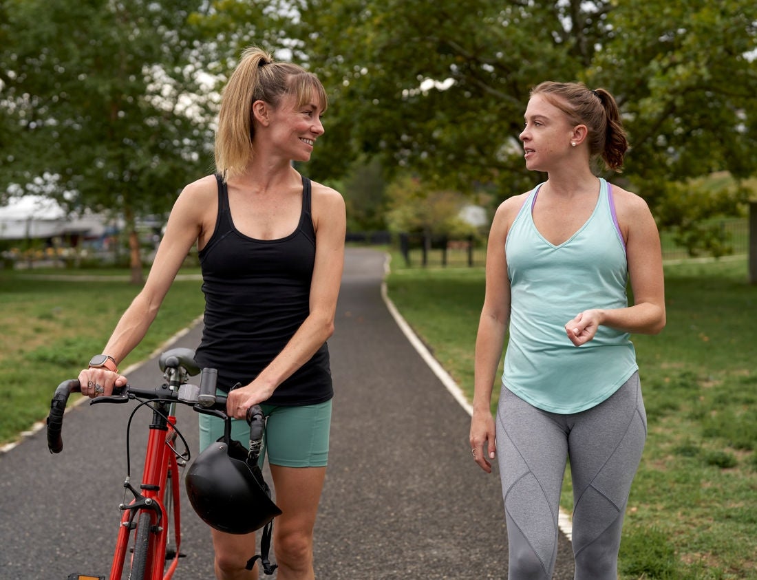 A woman talks  to her friend on a walk.