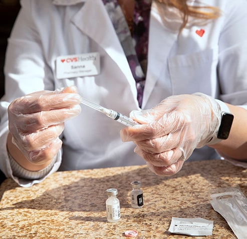 Female medical provider preparing a vaccine