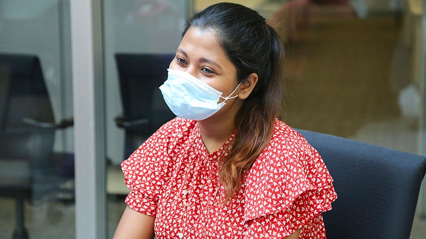 Woman smiling under her mask