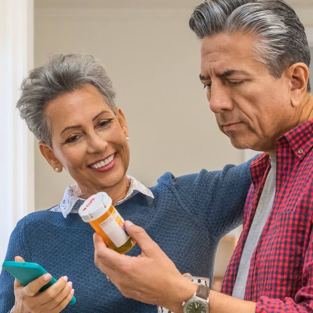 Older couple reading prescription label together