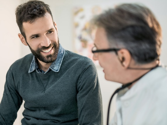 A man talking with his doctor